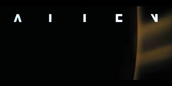 A frame from the title sequence of the movie Alien. It shows a distant planet with a brackish eclipse. Some disjointed bits of letters are overlaid along the top of the frame.