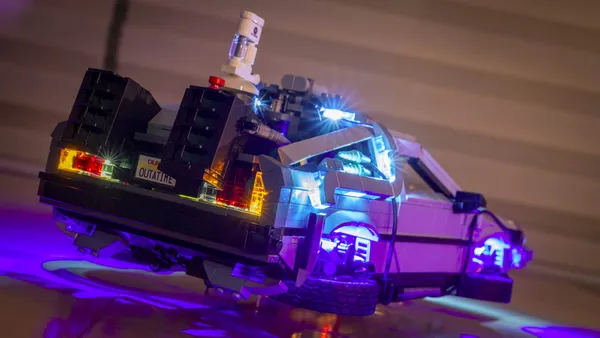 toy version of the delorean car from the movie back to the future. the car is equipped to fly like in the second movie in the trilogy.